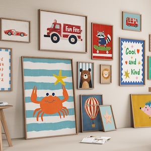 May include: A collection of framed art prints featuring various illustrations. The prints include a red fire truck, a crab holding a starfish, a raccoon on a skateboard, and an alphabet chart. The color palette includes red, blue, yellow, and brown.