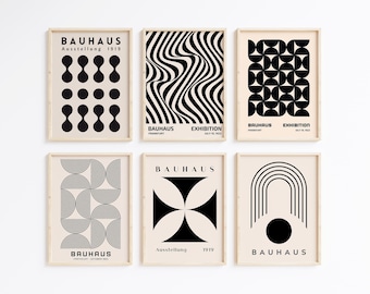 May include: Six framed black and white geometric art prints with the text "Bauhaus" and "Ausstellung 1919" on a white wall. The prints feature abstract designs with circles, squares, and lines.