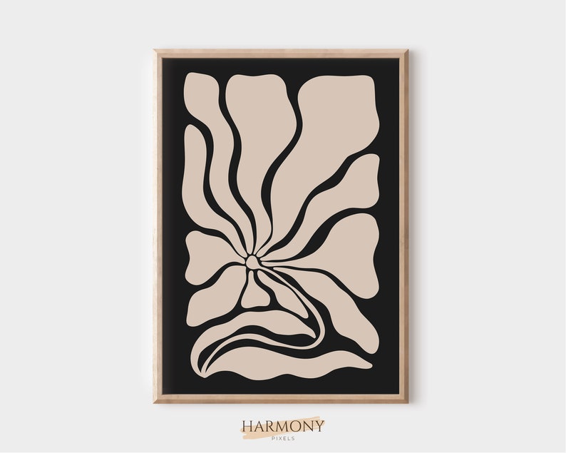 May include: Abstract art print featuring a beige flower with black outlines on a black background. The print is framed in a light wood frame.