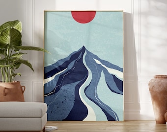 Puede incluir: Impresión de arte abstracto con una montaña azul y blanca con un sol rojo en el cielo. La impresión está enmarcada en un marco dorado.