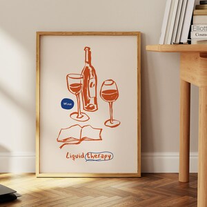 May include: A framed print with a hand-drawn illustration of a bottle of wine and two glasses. The text "Wine" and "Liquid Therapy" are included in the illustration.
