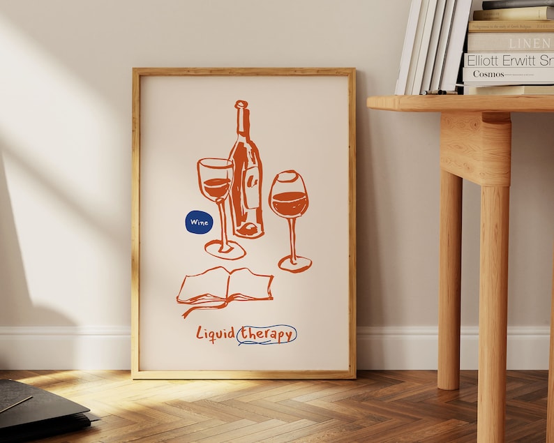 May include: A framed print with a hand-drawn illustration of a bottle of wine and two glasses. The text "Wine" and "Liquid Therapy" are included in the illustration.
