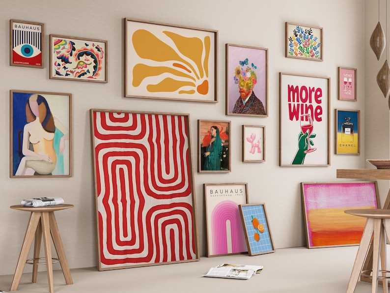 May include: A collection of framed art prints in various sizes and styles, including abstract designs, floral patterns, and portraits. The color palette includes red, yellow, blue, and pink, with wooden frames.