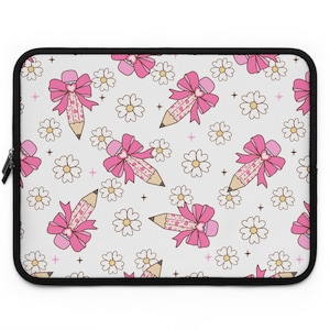 May include: A white laptop sleeve with a pink and white pattern of pencils with bows and daisies.