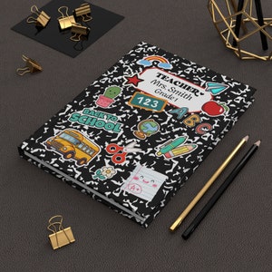 May include: Black and white notebook cover with colorful stickers. The stickers include a school bus, a rainbow, a cactus, a globe, scissors, a pencil, a red apple, and the letters ABC. The text on the cover reads "Teacher", "Mrs. Smith", "Grade 1", "123", and "Back to School".