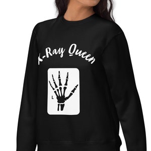 May include: Black sweatshirt with white text that reads "X-Ray Queen" and a white silhouette of an x-ray of a hand.
