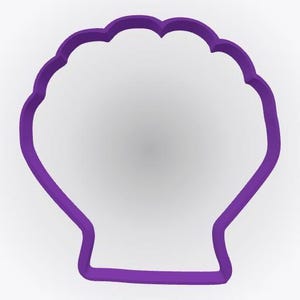 May include: A purple cookie cutter shaped like a scallop shell. The outline features a rounded top with multiple scalloped edges and a flat base. The frame is solid and uniform in color, creating a clear silhouette of a marine seashell form.