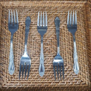 May include: A set of three ceramic mugs with a speckled, matte finish. The mugs are in shades of cream, light gray, and dark gray. Each mug has a simple, minimalist design, perfect for coffee or tea.