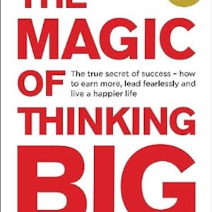May include: Book cover with the title "The Magic of Thinking Big" in red letters. The author's name, "David Schwartz, PhD", is printed in blue at the bottom of the cover. The cover also features a small circle with the text "6 Million Sold" in white letters on a red background.