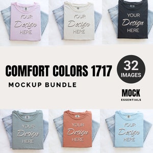 May include: A mockup bundle of 32 images featuring folded t-shirts in various colors. The t-shirts are laid flat on a white surface with a pair of blue jeans folded on top of each shirt. The text "YOUR DESIGN HERE" is printed on each shirt.