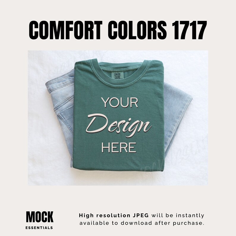 May include: A folded green t-shirt with the text "YOUR Design HERE" on it. The t-shirt is on top of a pair of blue jeans. The background is white.