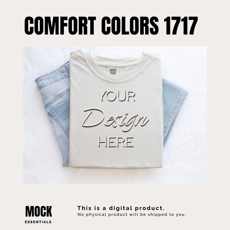 May include: A white t-shirt with the text "YOUR Design HERE" on it. The t-shirt is folded and laid on a white surface with a pair of blue jeans folded next to it.
