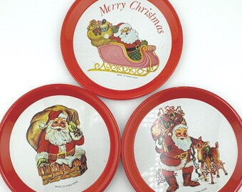 Vintage Metal Christmas Coasters Set of Three 3 Santa in Sleight Santa Going Down Chimney and Santa Petting Reindeer