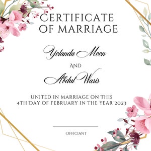 May include: A gold geometric frame with pink and white flowers on a white background. The text "CERTIFICATE OF MARRIAGE" is at the top of the frame. The names "Yolanda Moon" and "Abdul Waris" are below the text. The text "UNITED IN MARRIAGE ON THIS 4TH DAY OF FEBRUARY IN THE YEAR 2023" is below the names. The word "OFFICIANT" is at the bottom of the frame.