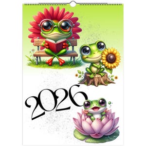May include: A calendar featuring cartoon frogs in various scenes. One frog wears glasses and reads a book, another holds a sunflower, and a third sits in a lotus flower. The year "2026" is displayed in large black numbers.
