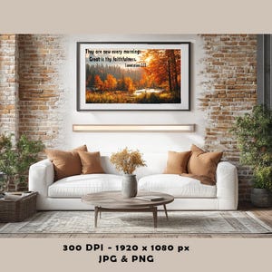 May include: A living room scene featuring a white sofa with brown throw pillows, a round wooden coffee table, and a framed landscape art piece. The artwork displays a fall scene with text: "They are new every morning: Great is thy faithfulness."