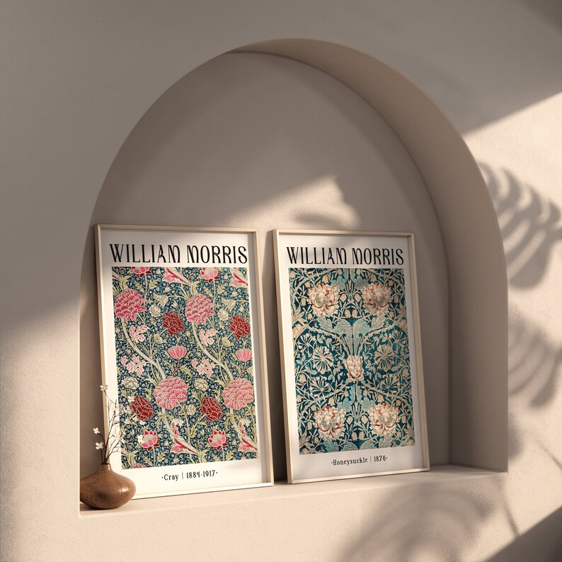 May include: Two framed prints of William Morris floral designs. The left print features a pink and green floral pattern with the text "Cray | 1887-1917". The right print features a blue and green floral pattern with the text "Honeysuckle | 1876".