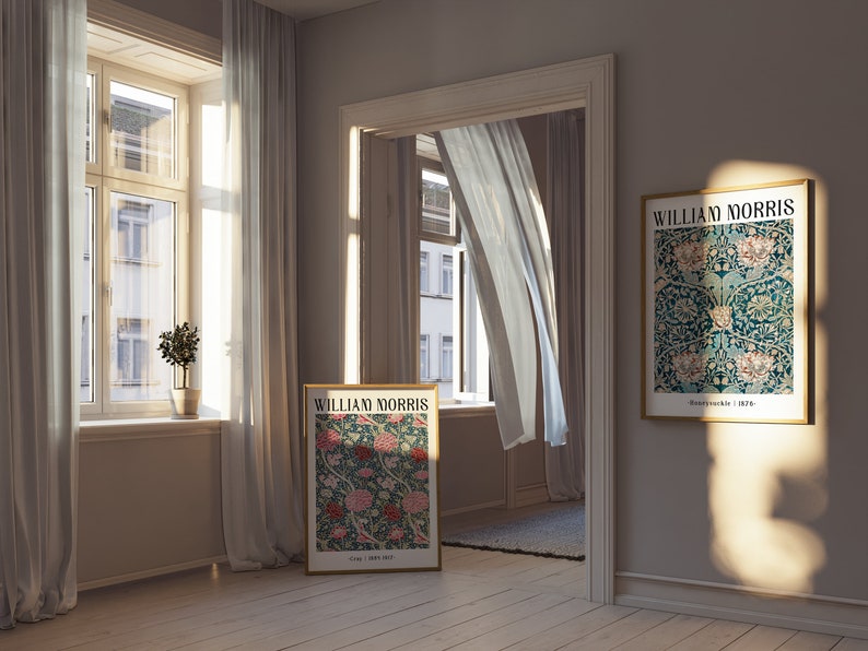 May include: Two framed posters with a floral pattern and the text "William Morris" in a light brown room with white curtains and a small potted plant.
