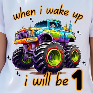 May include: A colorful monster truck with the text "when i wake up i will be 1" on a white t-shirt.