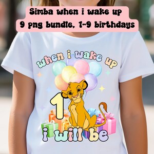 May include: White t-shirt featuring a Simba graphic with the text "when i wake up" and "i will be". The design includes a number 1, balloons, and gift boxes. The shirt is designed for birthdays.