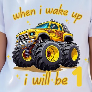May include: A yellow monster truck with flames on the side and the text "when i wake up i will be 1" on a white t-shirt.