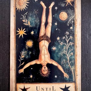 May include: Vintage-style tarot card depicting a figure inverted against a dark, starry backdrop. The card includes celestial and botanical details. The text at the bottom reads "UNTIL" and "What if the pause is the point?"