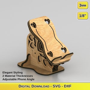 Puede incluir: Un soporte de teléfono de madera con un diseño decorativo de corazón. El soporte tiene un ángulo ajustable y está disponible en dos espesores: 3 mm y 1/8 de pulgada. DESCARGA DIGITAL - SVG - DXF