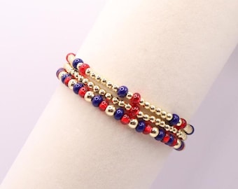 Pulsera azul marino y roja para el día del juego con cuentas rellenas de oro