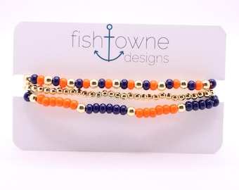 Conjunto de pulseras para el día del partido en azul marino y hematita naranja