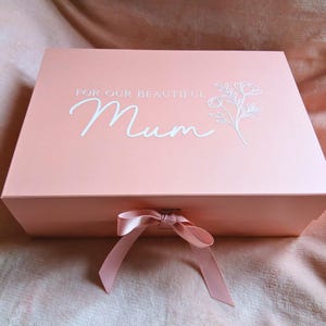 May include: A weathered wooden sign, inscribed with 'Welcome to our home' in a handwritten font. The sign has a distressed appearance, ideal for a front door or hallway, creating a welcoming atmosphere.