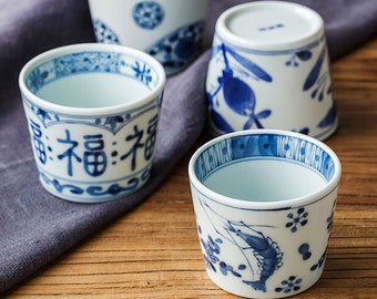 Japanese craft tea cup with traditional style painting of underglaze blue ink