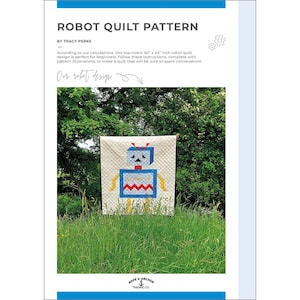 May include: A cream-colored robot quilt pattern with a blue, red, and yellow robot design. The quilt measures 40 x 44 inches. The text "ROBOT QUILT PATTERN" is at the top of the image. The quilt is displayed outdoors in front of green foliage.