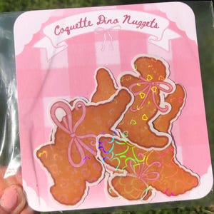 Coquette Dino Nuggets Sticker: Holographic Waterproof Vinyl Decal