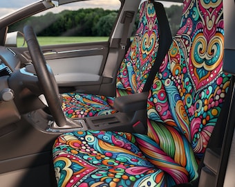Puede incluir: Un par de fundas para asientos de coche coloridas con un patrón psicodélico. Las fundas presentan una mezcla de colores brillantes, incluyendo rosa, azul, verde, amarillo y naranja. El patrón es abstracto e incluye espirales, puntos y otras formas geométricas.