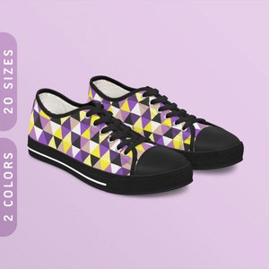 May include: A pair of black canvas low-top sneakers with a geometric pattern of yellow, purple, and white triangles.