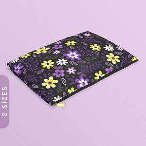 May include: A black zippered pouch with a floral pattern featuring purple, yellow, and white flowers on a black background.