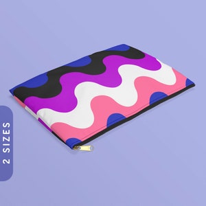May include: A colorful zippered pouch with a wavy abstract pattern in pink, blue, black, white, and purple. The pouch is lying on a light purple surface.