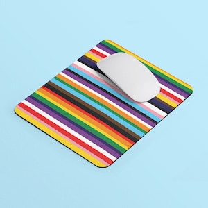 May include: A colourful striped mouse mat with a white computer mouse on top. The mouse mat has a variety of colours, including red, orange, yellow, green, blue, purple, and pink.