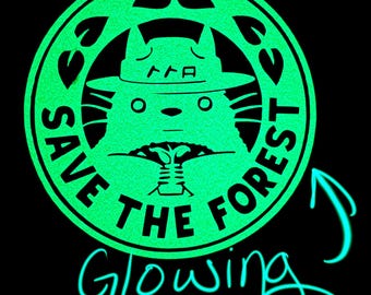 May include: A circular, glowing green emblem on a black background featuring a stylized creature wearing a hat. The text "SAVE THE FOREST" is printed in a circular border, with the word "Glowing" and an arrow pointing to the emblem below.