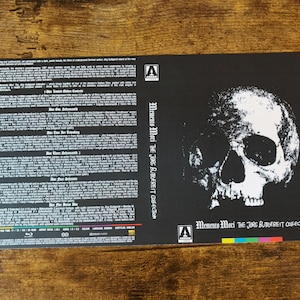 May include: Black and white DVD case with a skull graphic and the text "Memento Mori The Jorg Butgereit Collection".