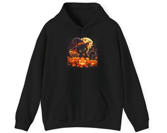 May include: A black hooded sweatshirt featuring a central graphic print of a black cat wearing a purple witch hat, sitting atop glowing orange jack-o'-lanterns with a full moon, bats, and a dark silhouette of a house in the background.