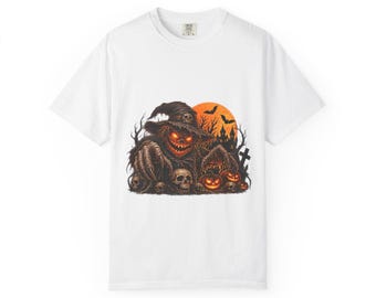 May include: A white short-sleeved t-shirt featuring a graphic print of a dark, hooded figure with glowing orange eyes and a jagged mouth. The scene includes skulls, carved pumpkins, a large orange moon, bats, and a silhouette of a graveyard.