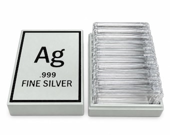 May include: A rectangular silver-colored storage box with a lid featuring the text Ag, .999, and FINE SILVER in black. Beside the box is a matching base containing a stack of clear, rectangular plastic protective cases for coins or bars.