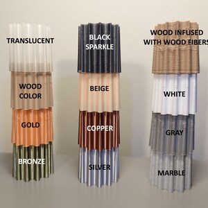May include: A set of six stacked, corrugated plastic tubes in various colors, including translucent, black sparkle, beige, wood color, gold, copper, white, gray, bronze, silver, and marble. The tubes are labeled with their corresponding colors.