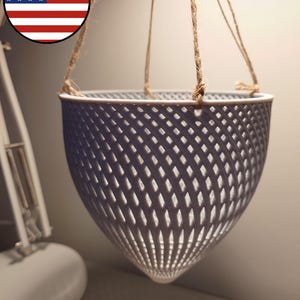 May include: A gray hanging planter made of a lattice design with a rope hanger.