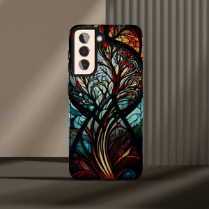 May include: A black phone case with a colorful stained glass design featuring a tree with intricate branches and leaves. The design is in shades of blue, green, yellow, orange, and red.