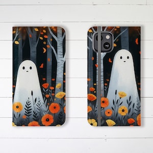 May include: A phone case with a spooky forest scene featuring a white ghost, orange and yellow flowers, and a dark blue background. The case has a black strap.