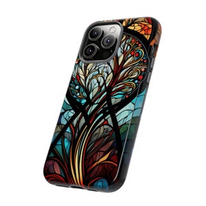 May include: A black phone case with a colorful stained glass design featuring a tree with blue, red, orange, and yellow accents.