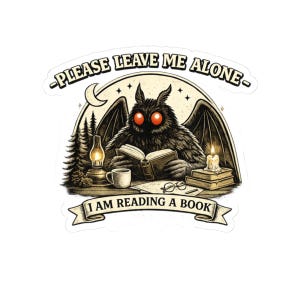 May include: A sticker depicting a creature with red eyes, reading a book. The creature has large wings and is surrounded by a lamp, a cup, and a candle. The text reads "PLEASE LEAVE ME ALONE" and "I AM READING A BOOK."