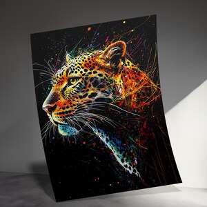 May include: A vibrant art print featuring a leopard's profile against a black background. The artwork uses a colorful splatter effect with orange, yellow, blue, and green hues, creating a dynamic and eye-catching design. The leopard's spots are detailed.